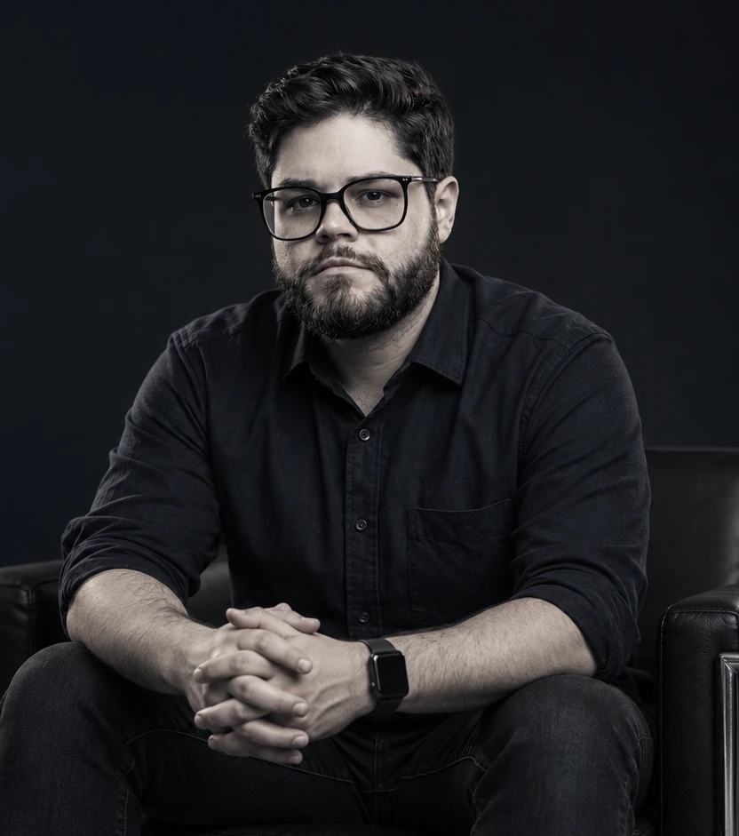 Patrick Domiciano seated in a black shirt, looking forward.